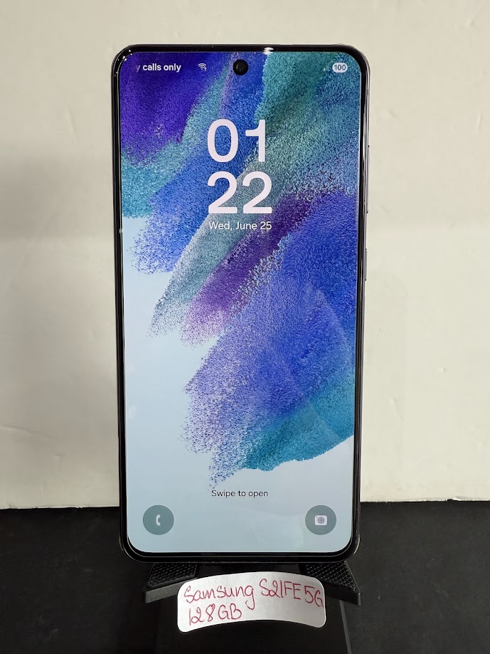 Samsung Galaxy smartphone on a stand, front screen shows large 01:22 time and 'Swipe to open' prompt, vertical orientation.