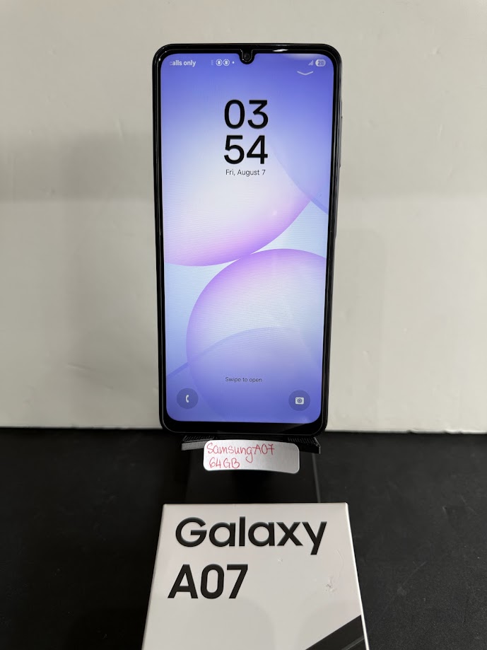 Samsung Galaxy A07 smartphone on a display stand with its white Galaxy A07 box in front; handwritten tag reads 'Samsung A07 64GB'